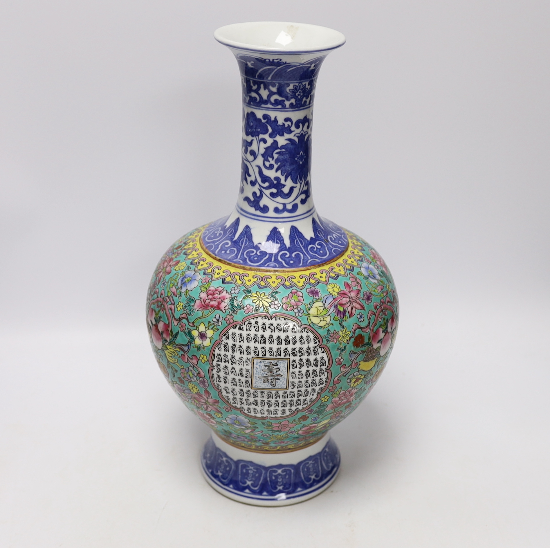 A Chinese famille rose vase, decorated with peaches and flowers, 35cm high